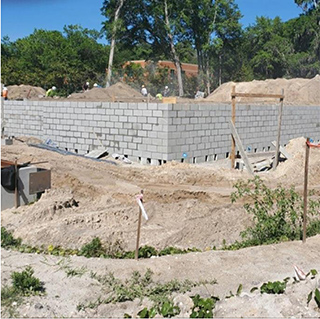 a picture of a construction site with a CMU wall partially built